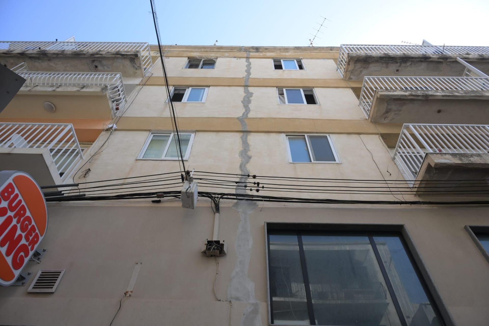 Repair work on the apartment block's wall.