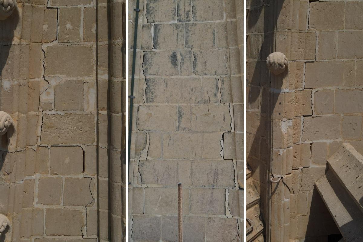 The several cracks along the different sides of the spire.