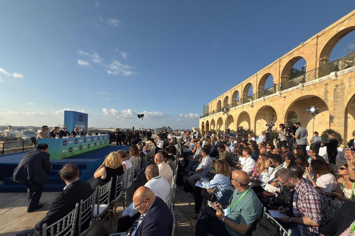 Delegates at the tourism global summit enjoy the autumn sun during the opening session at the Upper Barrakka Gardens.