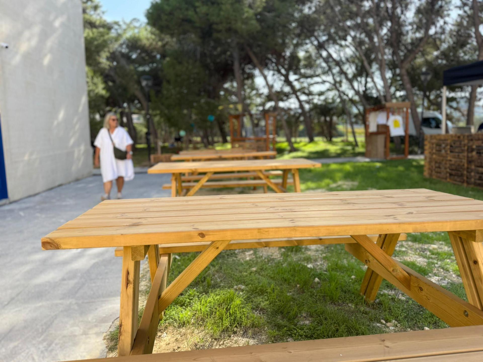 An outdoor beer garden surrounded by trees.