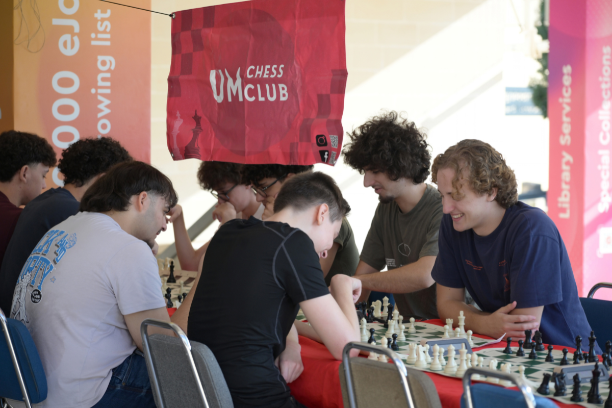 Students playing chess in front of the university library at a game organised by the UM chess club. Photo: Matthew Mirabelli